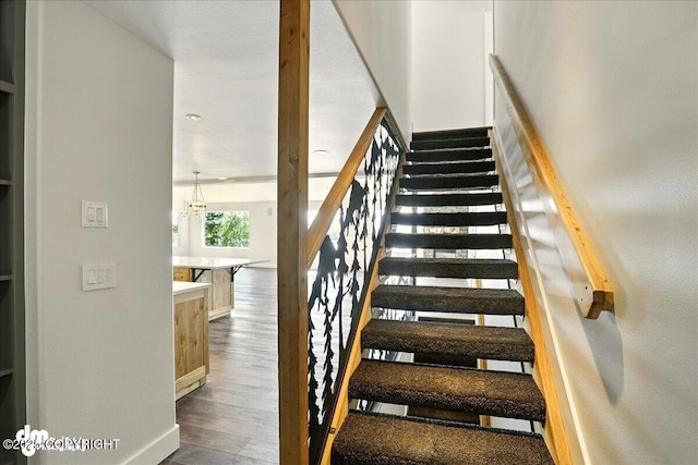 5100 W Lakeside Dr, Wasilla, AK 99654 - stairs with wood finished floors and a chandelier