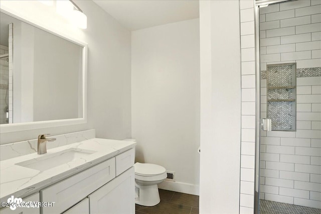 5100 W Lakeside Dr, Wasilla, AK 99654 - full bathroom with a stall shower, vanity, and wood finished floors
