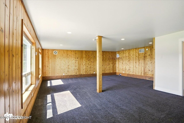 5100 W Lakeside Dr, Wasilla, AK 99654 - spare room with dark carpet, wood walls, and recessed lighting