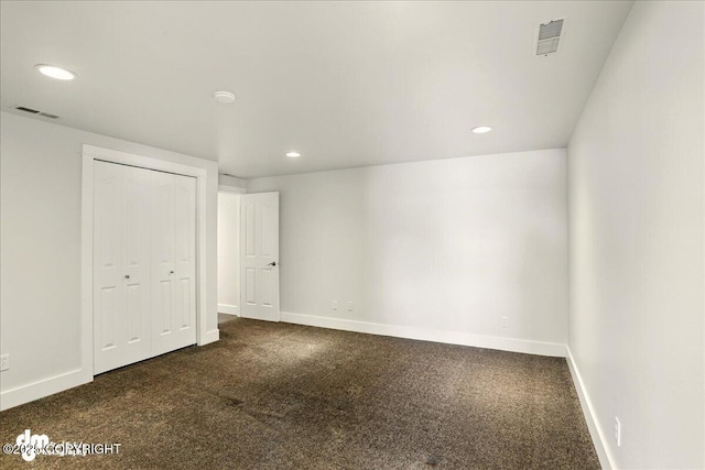 5100 W Lakeside Dr, Wasilla, AK 99654 - unfurnished bedroom featuring dark carpet, recessed lighting, and a closet