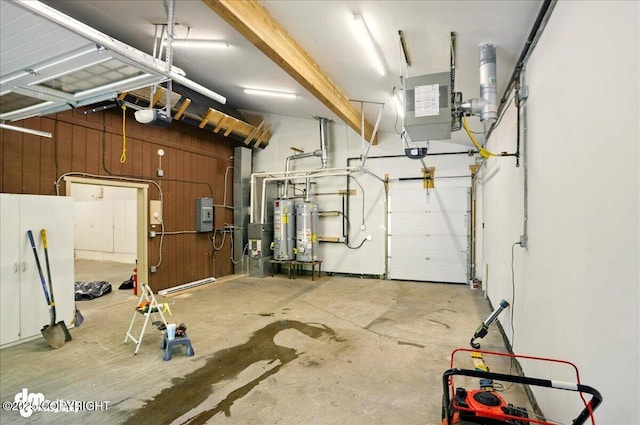 5100 W Lakeside Dr, Wasilla, AK 99654 - garage with strapped water heater, a garage door opener, and a heating unit