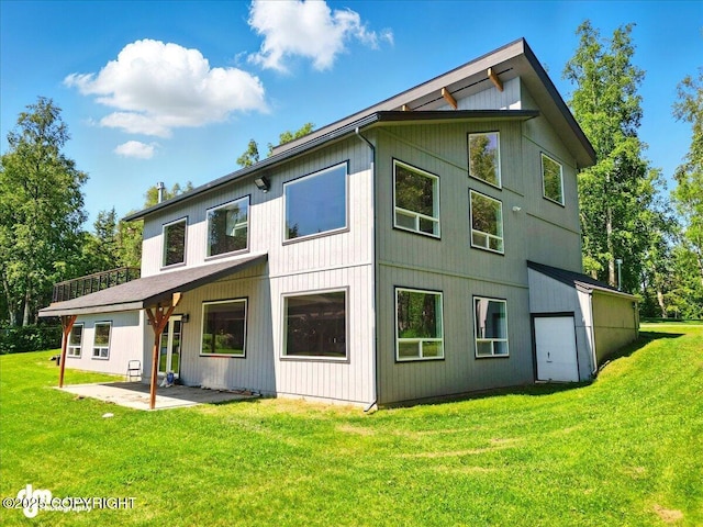 5100 W Lakeside Dr, Wasilla, AK 99654 - back of property featuring a lawn and a patio