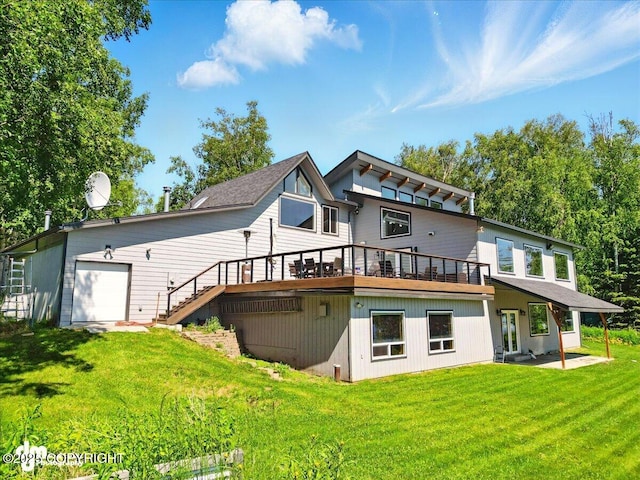 5100 W Lakeside Dr, Wasilla, AK 99654 - back of property featuring a lawn, a deck, and a garage
