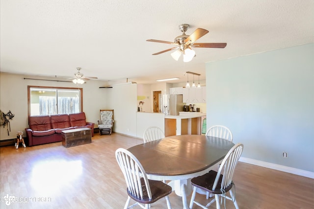 3401 Lois Dr, Anchorage, AK 99517 - dining room featuring ceiling fan, light wood finished floors, and a textured ceiling