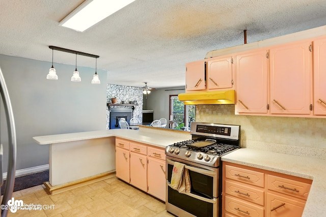 3401 Lois Dr, Anchorage, AK 99517 - kitchen with range with two ovens, under cabinet range hood, a textured ceiling, a peninsula, and tasteful backsplash