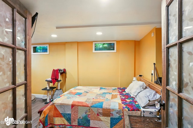 3401 Lois Dr, Anchorage, AK 99517 - bedroom with wood finished floors, multiple windows, and recessed lighting