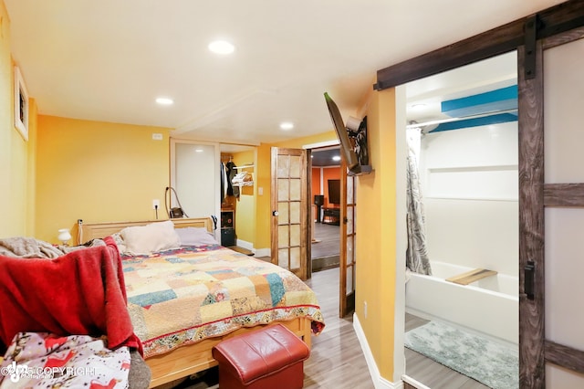 3401 Lois Dr, Anchorage, AK 99517 - bedroom with recessed lighting, wood finished floors, a closet, and a barn door