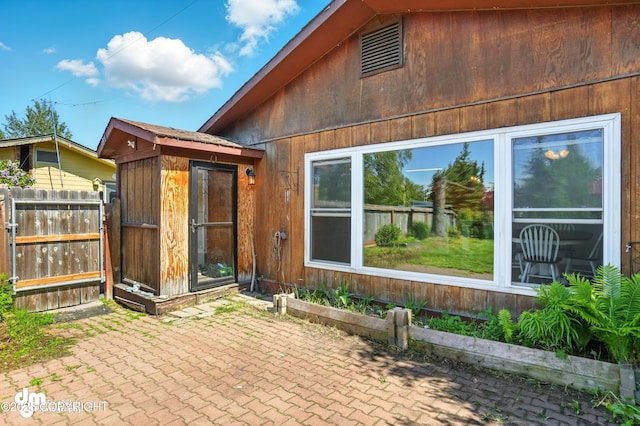 3401 Lois Dr, Anchorage, AK 99517 - rear view of property with a patio and an outdoor structure