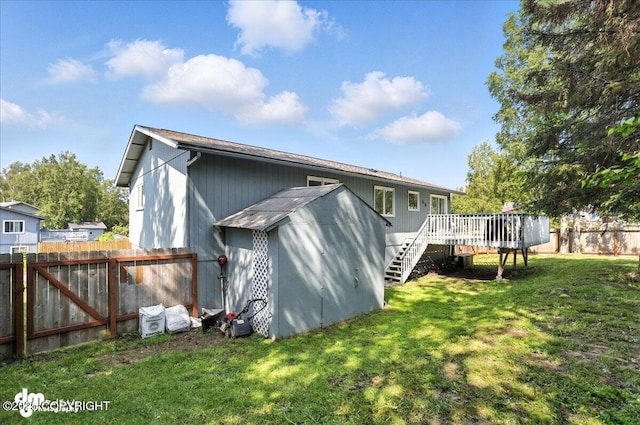 13481 Baywind Dr, Anchorage, AK 99516 - back of property featuring a deck, a fenced backyard, and stairway