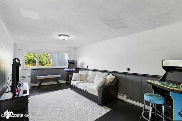 13481 Baywind Dr, Anchorage, AK 99516 - living room featuring a baseboard heating unit, a textured ceiling, and a textured wall