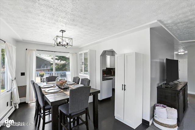 13481 Baywind Dr, Anchorage, AK 99516 - dining space featuring a chandelier, a textured ceiling, and arched walkways