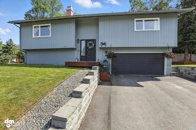 13481 Baywind Dr, Anchorage, AK 99516 - split foyer home featuring a garage, driveway, a chimney, and a front lawn