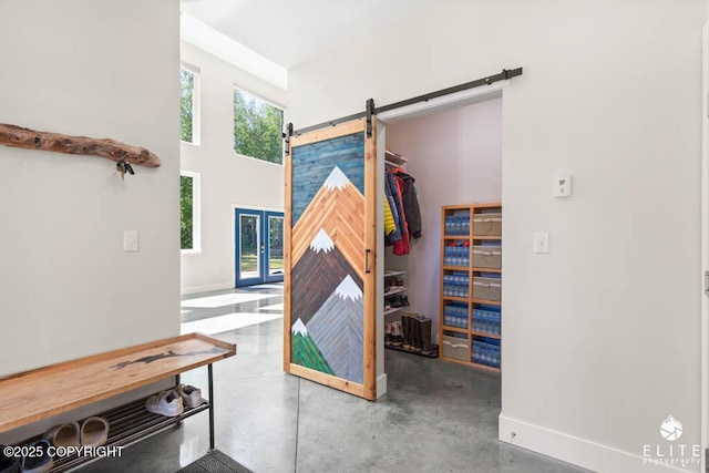4722 S Gon Fishin Dr, Wasilla, AK 99623 - misc room with a barn door, concrete floors, and a high ceiling