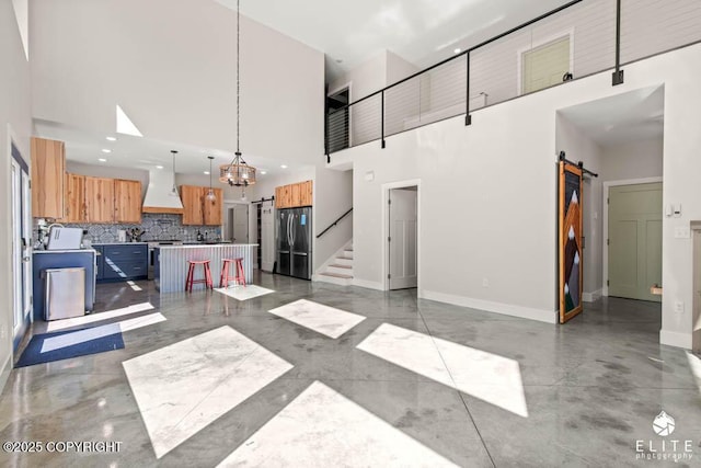 4722 S Gon Fishin Dr, Wasilla, AK 99623 - kitchen featuring a barn door, freestanding refrigerator, a high ceiling, custom range hood, and a chandelier