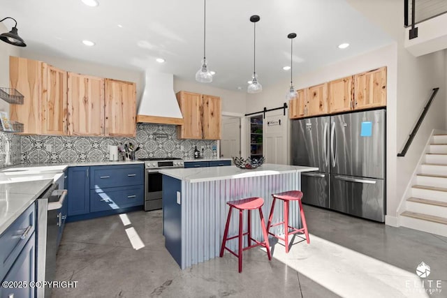 4722 S Gon Fishin Dr, Wasilla, AK 99623 - kitchen with stainless steel appliances, custom exhaust hood, finished concrete flooring, recessed lighting, and a barn door