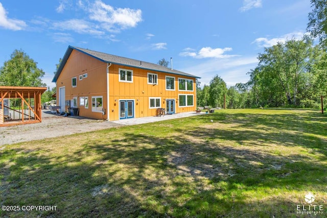 4722 S Gon Fishin Dr, Wasilla, AK 99623 - back of property with french doors, a patio, board and batten siding, and a lawn
