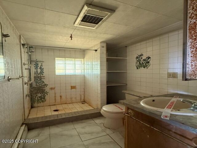 2030 Haydon Ct, Fairbanks, AK 99701 - full bath with vanity, a shower stall, tile walls, and tile patterned floors