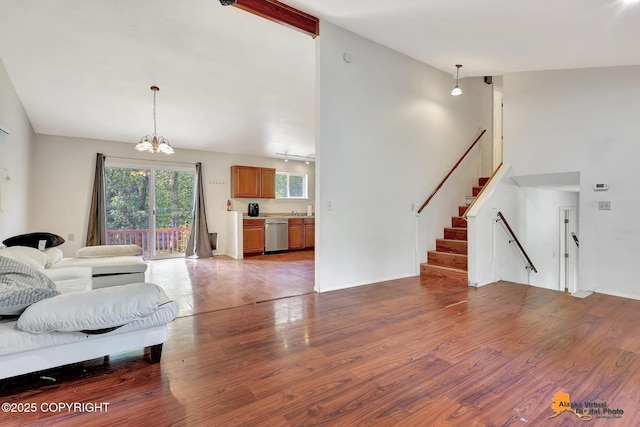 3150 E Escondido Ave, Wasilla, AK 99654 - living room featuring a chandelier, wood finished floors, stairs, and high vaulted ceiling