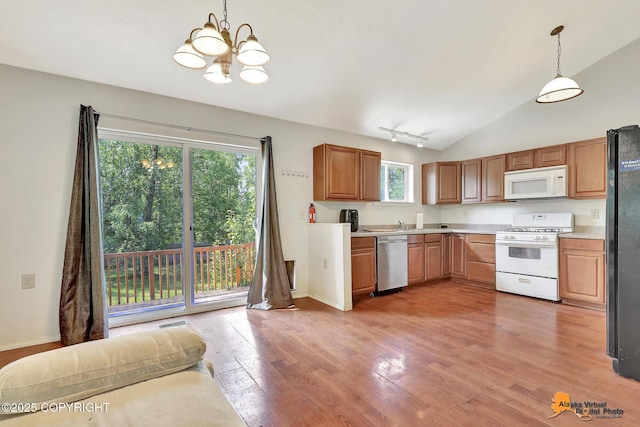 3150 E Escondido Ave, Wasilla, AK 99654 - kitchen with white appliances, healthy amount of natural light, a chandelier, light countertops, and lofted ceiling