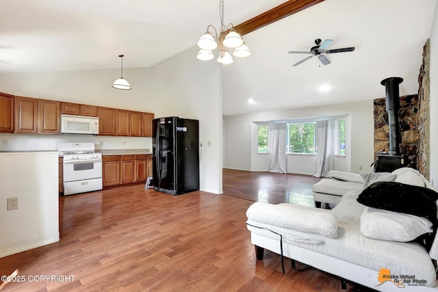 3150 E Escondido Ave, Wasilla, AK 99654 - living room featuring a wood stove, ceiling fan, high vaulted ceiling, light wood finished floors, and beamed ceiling