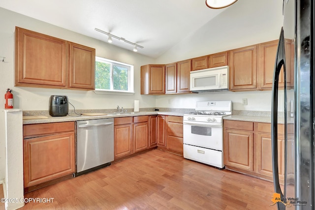 3150 E Escondido Ave, Wasilla, AK 99654 - kitchen featuring white appliances, lofted ceiling, light wood-style floors, light countertops, and track lighting