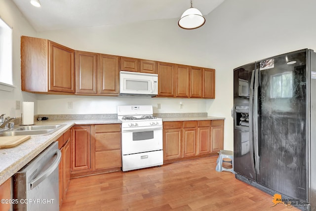 3150 E Escondido Ave, Wasilla, AK 99654 - kitchen with white appliances, light countertops, light wood-type flooring, high vaulted ceiling, and brown cabinets