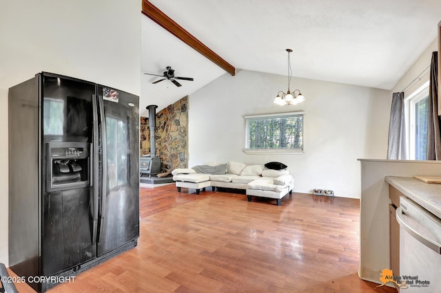 3150 E Escondido Ave, Wasilla, AK 99654 - living room with light wood-style flooring, ceiling fan, a wood stove, and a chandelier