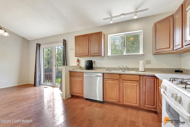 3150 E Escondido Ave, Wasilla, AK 99654 - kitchen featuring dishwasher, white gas range oven, light countertops, light wood-style floors, and brown cabinetry