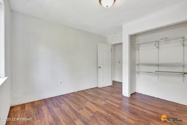 3150 E Escondido Ave, Wasilla, AK 99654 - unfurnished bedroom featuring a closet and wood finished floors
