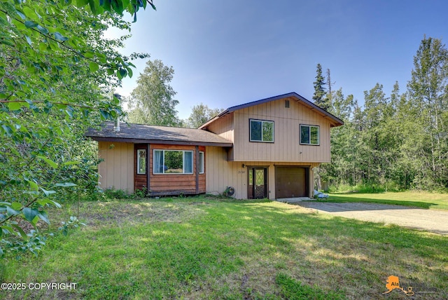 3150 E Escondido Ave, Wasilla, AK 99654 - tri-level home with driveway, a garage, and a front yard