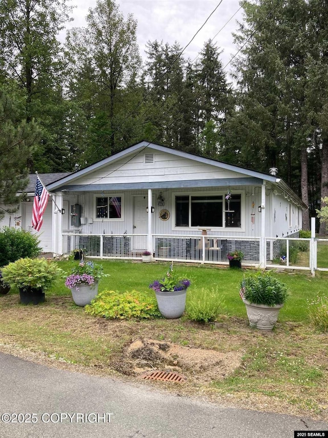 4128 Taku Blvd, Juneau, AK 99801 - view of front of house with a porch, a front yard, and board and batten siding