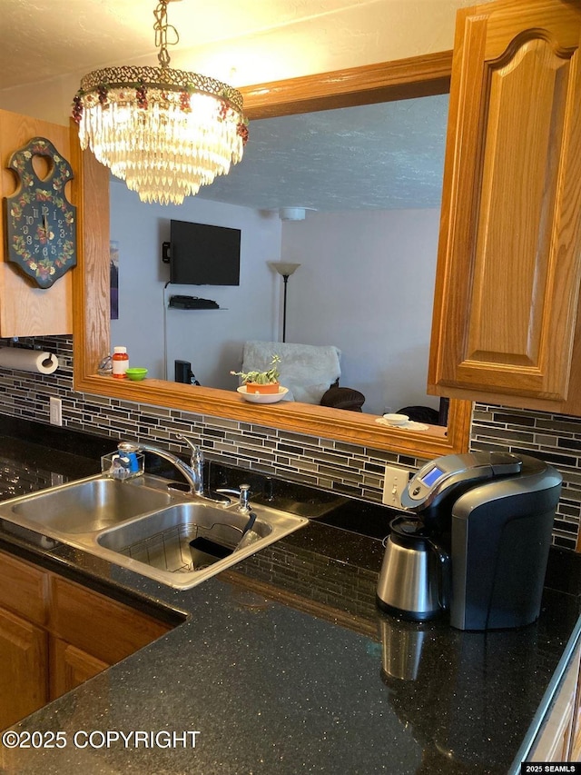 4128 Taku Blvd, Juneau, AK 99801 - kitchen view of tasteful backsplash, a chandelier, and brown cabinetry
