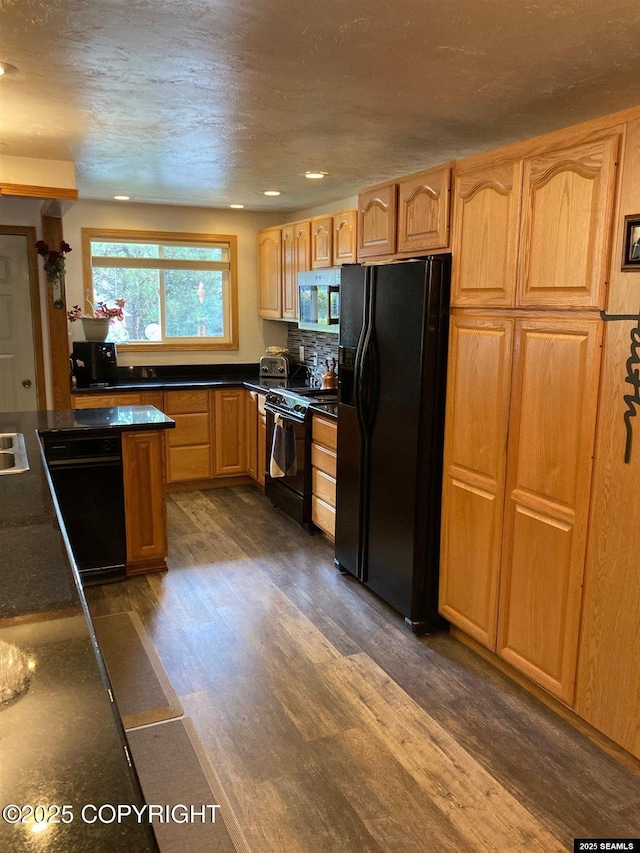 4128 Taku Blvd, Juneau, AK 99801 - kitchen with black appliances, dark countertops, dark wood-style flooring, and recessed lighting