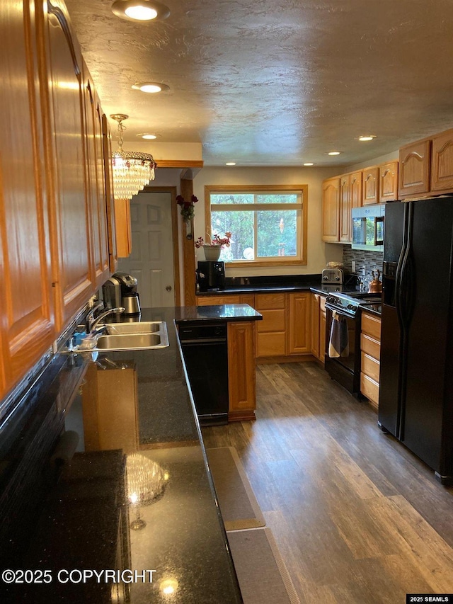 4128 Taku Blvd, Juneau, AK 99801 - kitchen featuring black appliances, dark countertops, dark wood-type flooring, recessed lighting, and decorative backsplash