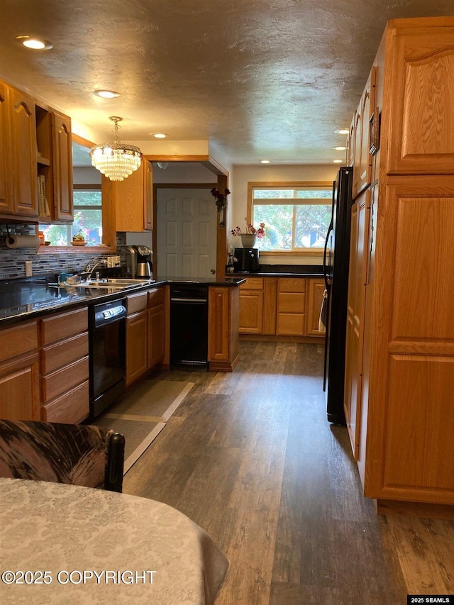 4128 Taku Blvd, Juneau, AK 99801 - kitchen featuring black appliances, healthy amount of natural light, a chandelier, dark wood-style floors, and recessed lighting