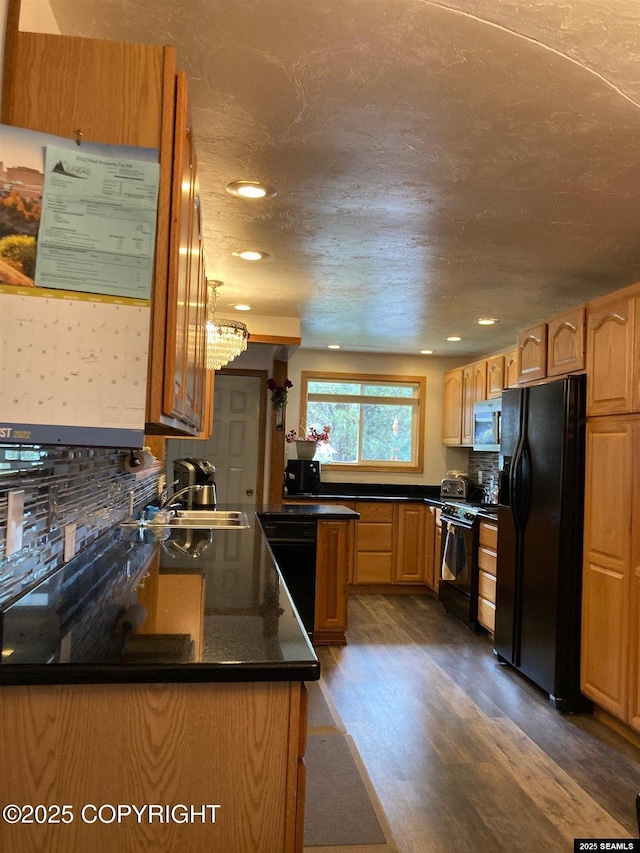4128 Taku Blvd, Juneau, AK 99801 - kitchen featuring black appliances, dark wood-style floors, dark countertops, recessed lighting, and backsplash
