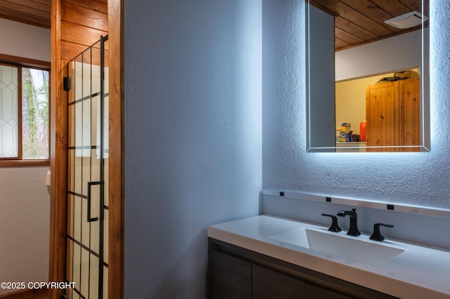 413 N Higgins Ct, Ketchikan, AK 99901 - bathroom featuring a textured wall, wood ceiling, and vanity