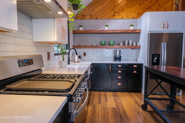 413 N Higgins Ct, Ketchikan, AK 99901 - kitchen featuring stainless steel appliances, range hood, open shelves, light wood-type flooring, and white cabinets