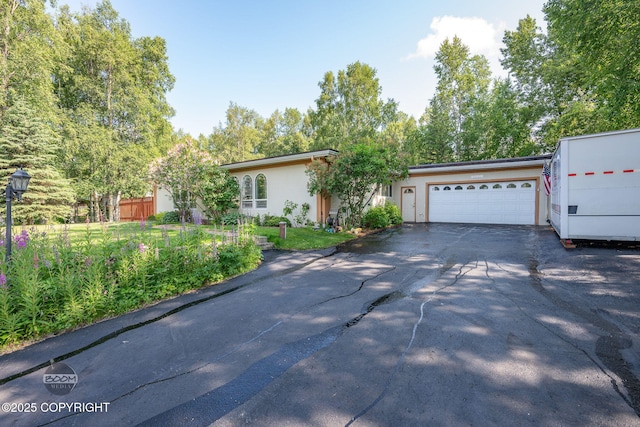 14121 Sunview Dr, Anchorage, AK 99515 - view of front facade with driveway, a garage, and stucco siding