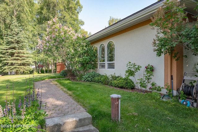 14121 Sunview Dr, Anchorage, AK 99515 - view of side of property with stucco siding and a lawn