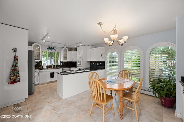 14121 Sunview Dr, Anchorage, AK 99515 - kitchen featuring white appliances, a chandelier, dark countertops, white cabinetry, and light tile patterned flooring