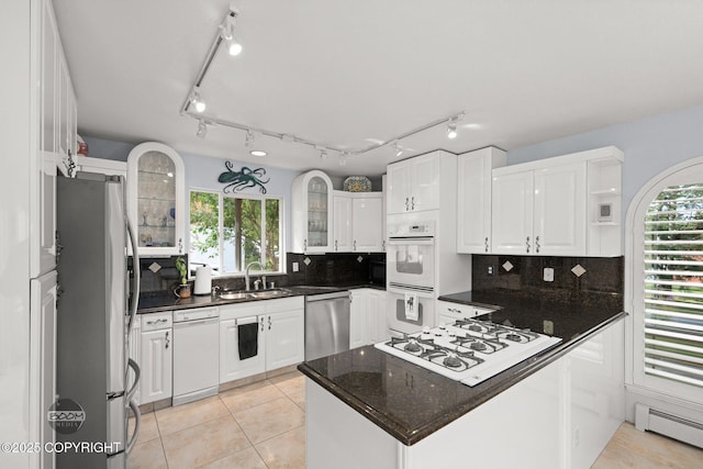 14121 Sunview Dr, Anchorage, AK 99515 - kitchen with stainless steel appliances, white cabinets, a peninsula, and plenty of natural light