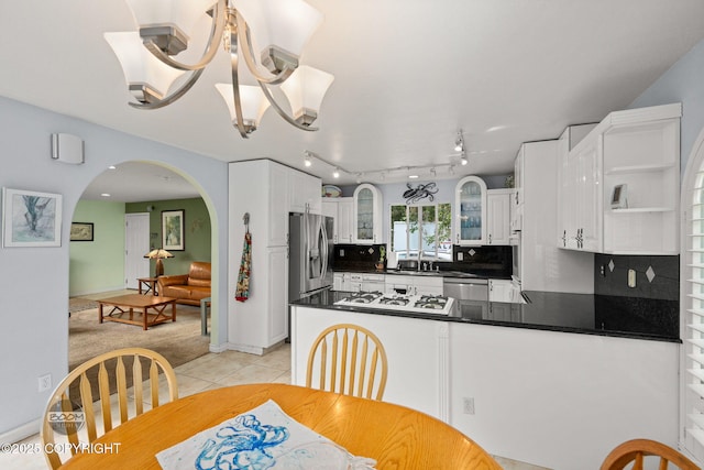 14121 Sunview Dr, Anchorage, AK 99515 - kitchen featuring stainless steel appliances, dark countertops, glass insert cabinets, and light tile patterned flooring