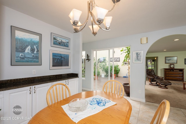 14121 Sunview Dr, Anchorage, AK 99515 - dining room with light tile patterned flooring, arched walkways, a chandelier, light carpet, and recessed lighting