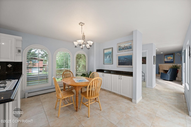 14121 Sunview Dr, Anchorage, AK 99515 - dining space with baseboard heating, a chandelier, and light tile patterned floors