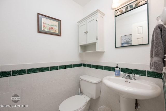 14121 Sunview Dr, Anchorage, AK 99515 - half bath featuring tile walls and a wainscoted wall
