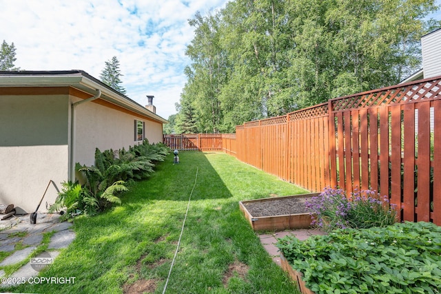 14121 Sunview Dr, Anchorage, AK 99515 - fenced backyard featuring a vegetable garden