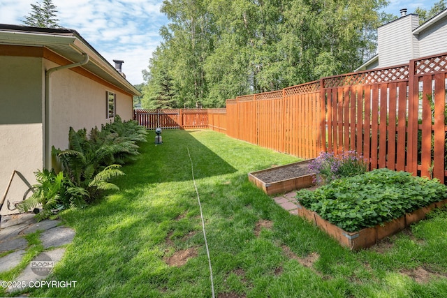 14121 Sunview Dr, Anchorage, AK 99515 - fenced backyard featuring a garden