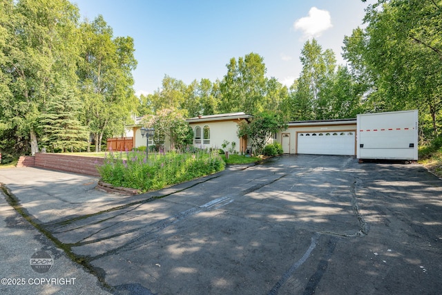 14121 Sunview Dr, Anchorage, AK 99515 - view of front of house featuring asphalt driveway and a garage