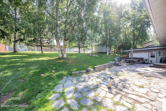 14121 Sunview Dr, Anchorage, AK 99515 - view of grassy yard with a patio, outdoor dining space, and an outbuilding